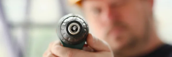 Arms of worker using electric drill closeup — Stock Photo, Image