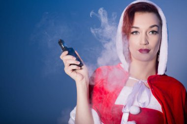 Noel Baba kıyafetli bir kızıl saçlı kadın