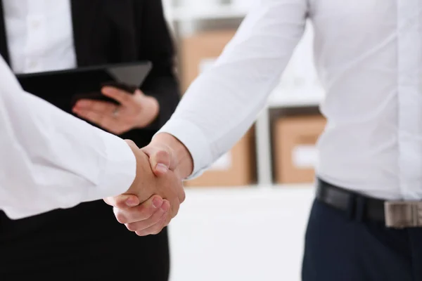 Smiling man in suit shake hands as hello