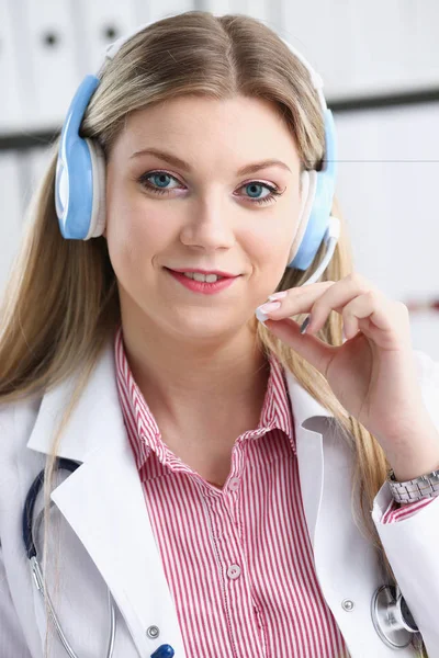 Portrait of happy smiling young doctor in headset