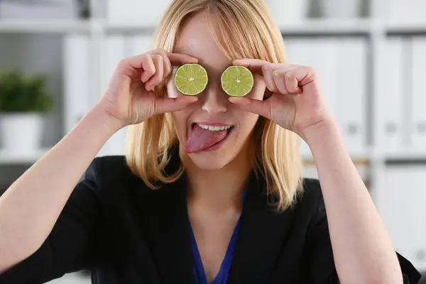 Mãos femininas segurar uma fruta de corte no nível dos olhos — Fotografia de Stock