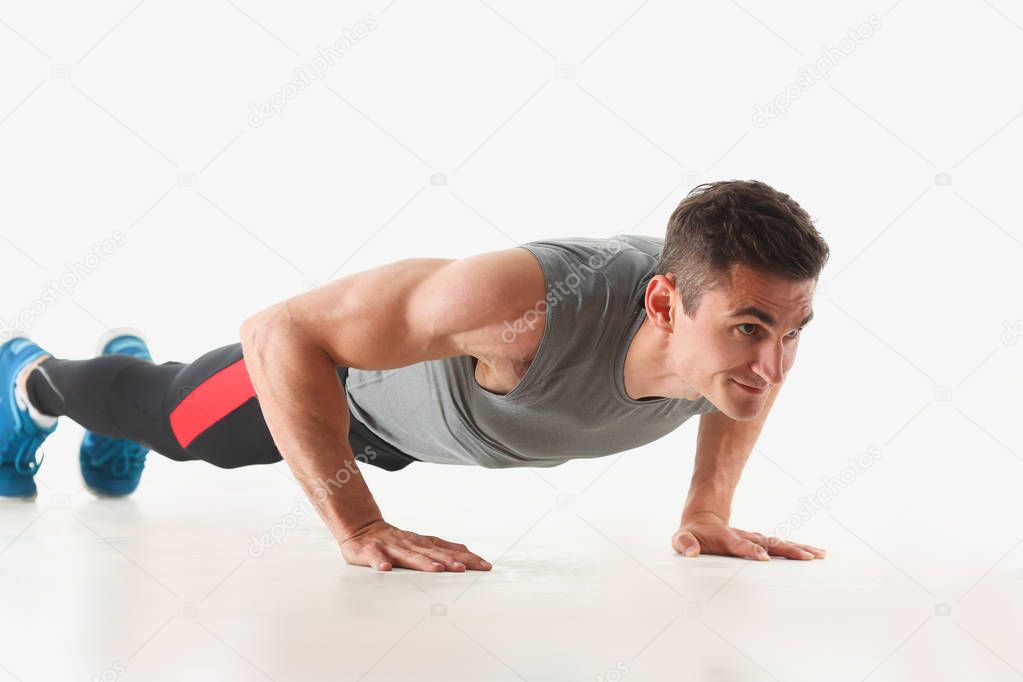Fitness man wringing from the floor demonstrates