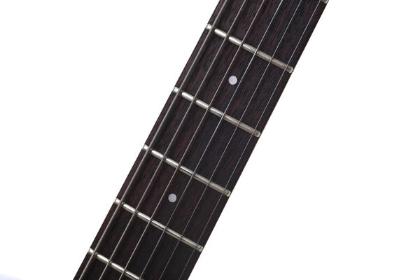 Empty wooden rosewood fingerboard of classic electric guitar closeup. Six strings free frets and fretboard dots acoustic musical instrument shop or learning school concept