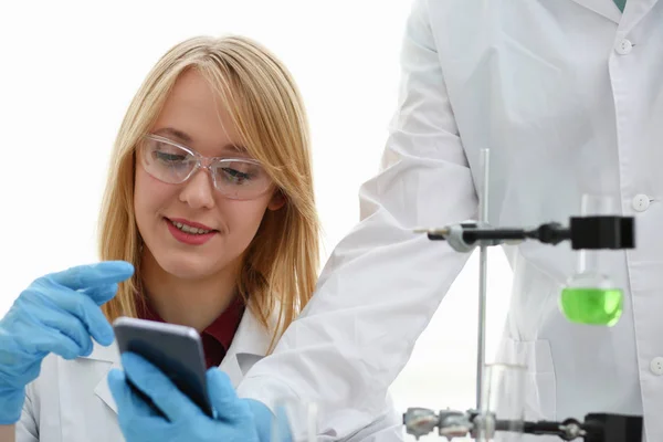 A female doctor in a chemical laboratory holds — Stock Photo, Image