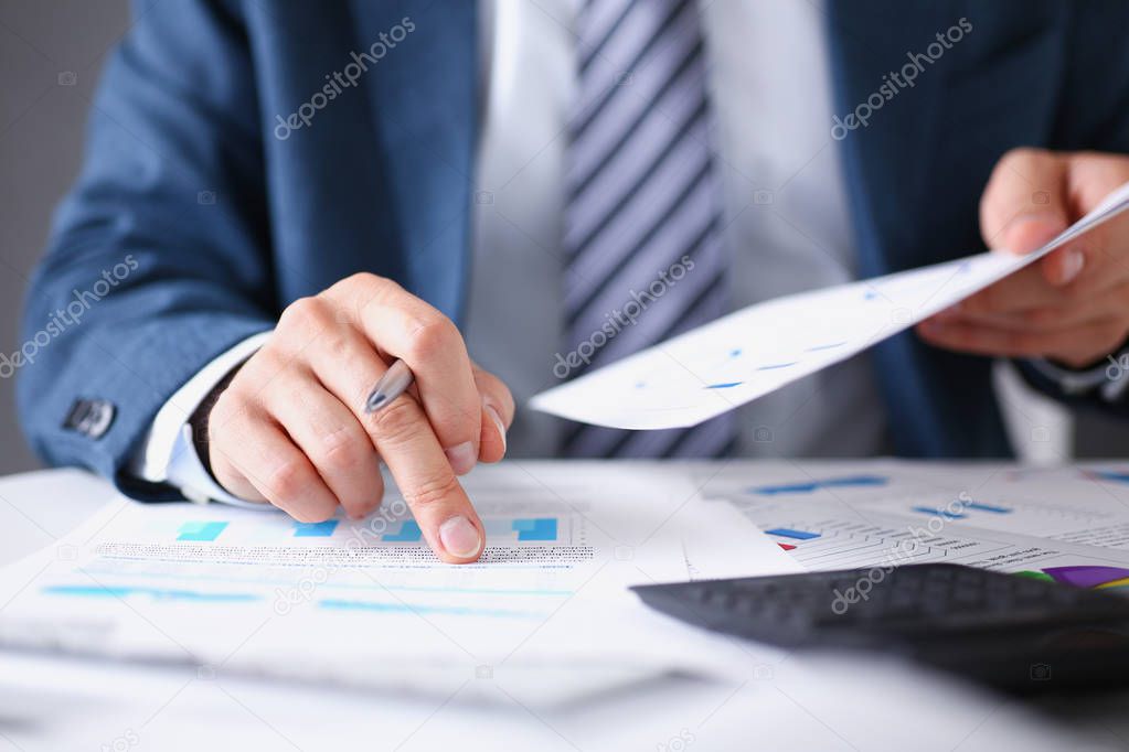 Male hands hold documents laptop with financial