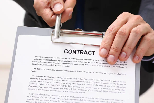 Male arm in suit offer contract form on — Stock Photo, Image