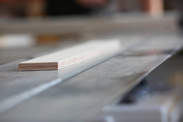 Wooden bars lying in a row closeup background. DIY job inspiration improvement fix shop powersaw bench joinery startup workplace idea career ruler industrial education