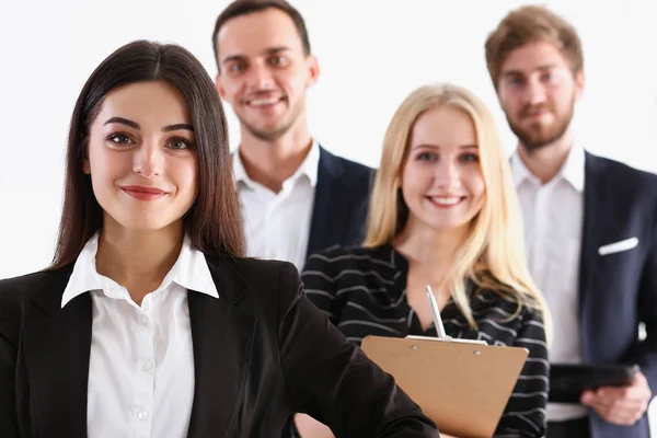 Group of smiling people stand in office looking