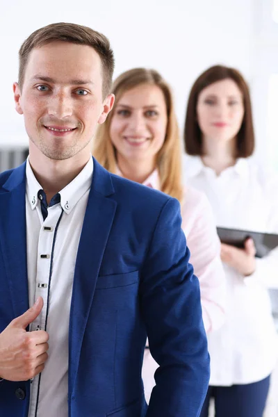 Group of smiling people stand in office looking — Stock Photo, Image