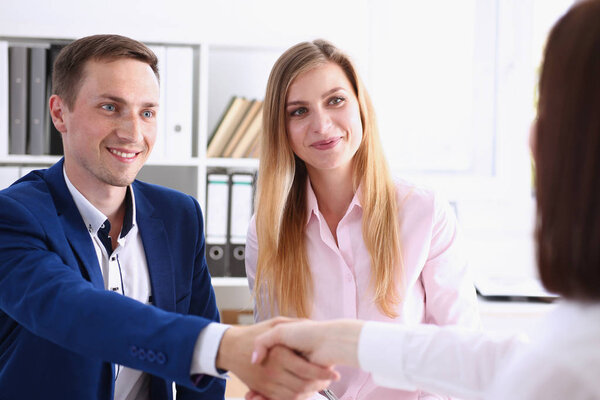 Smiling man and woman shake hands