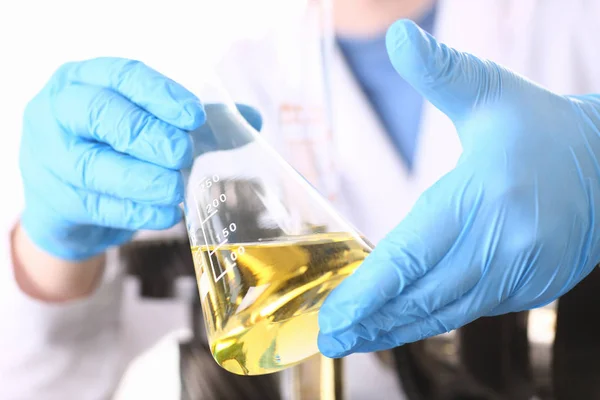 Male hands in protective gloves hold test tube — Stock Photo, Image