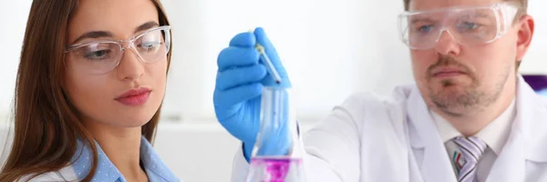 Technician hold in arms in protective gloves sample bottle — Stock Photo, Image