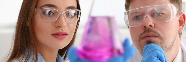 Technician hold in arms in protective gloves sample bottle — Stock Photo, Image