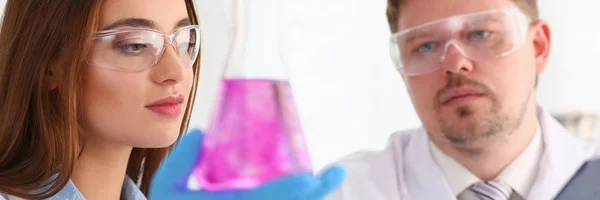 Technician hold in arms in protective gloves sample bottle — Stock Photo, Image