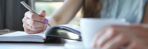 business people in cafe coffee break at table hold cup of coffee in arm