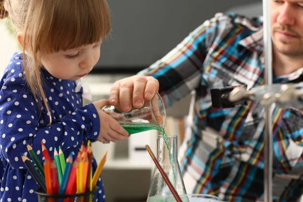 Man and little girl play with colourful liquids — Stock Photo, Image