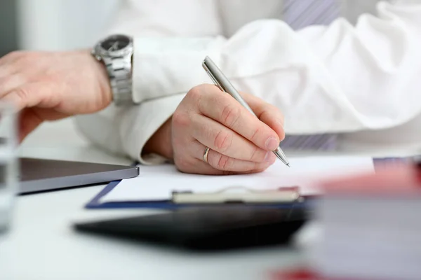 Male arm in suit and tie hold silver pen Stock Photo