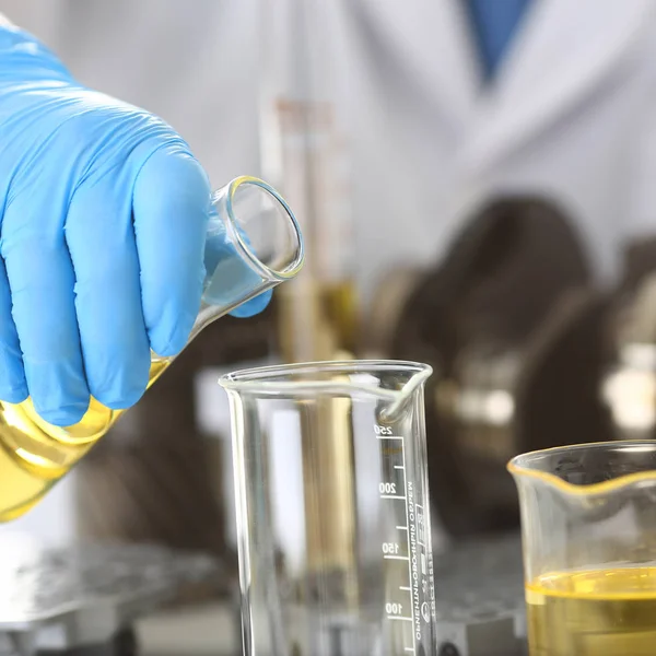 Mannelijke handen in beschermende handschoenen houden reageerbuis — Stockfoto