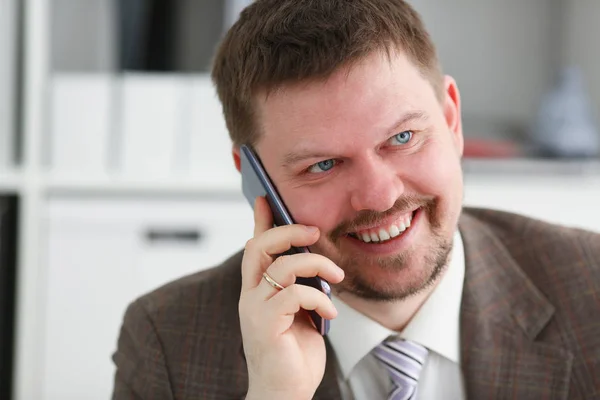 Handsome smiling businessman talk cellphone