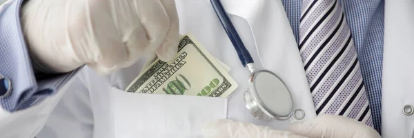 Male doctor hand in white gloves shoves — Stock Photo, Image