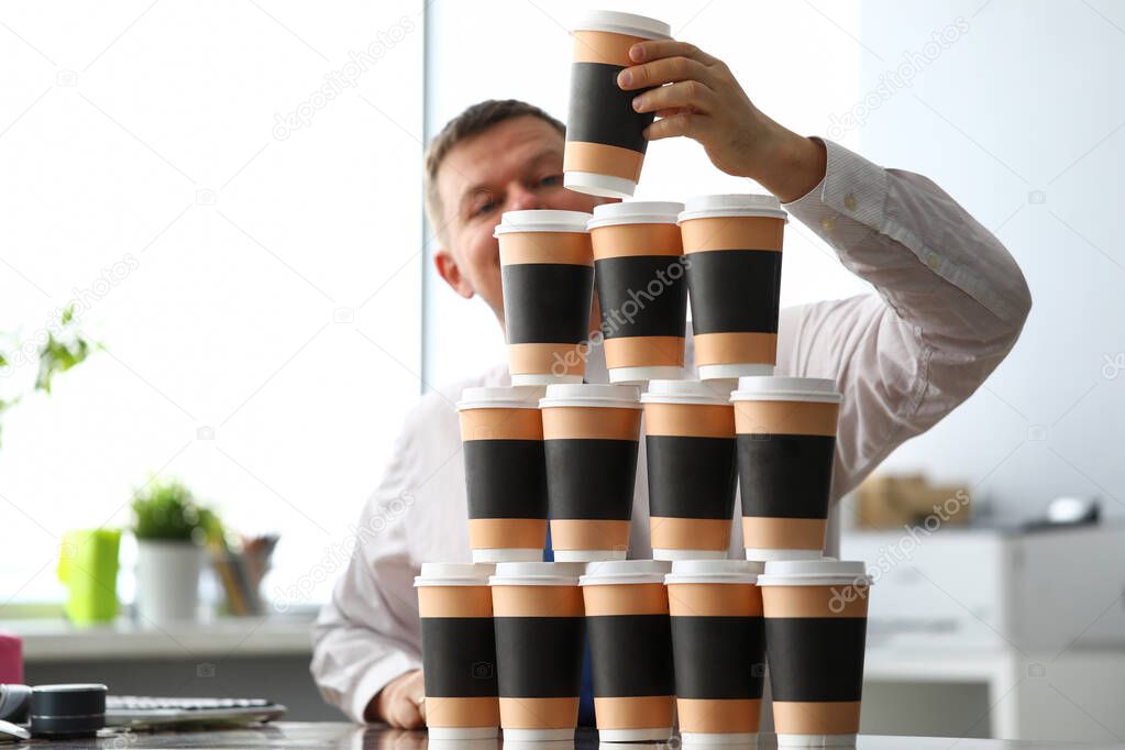 Stupid office clerk making huge tower out of paper cups