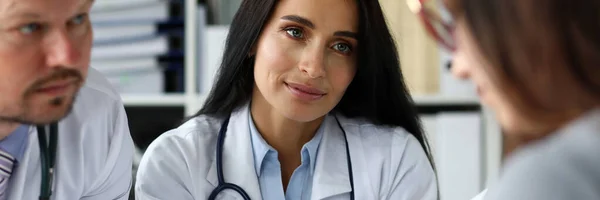 Group of GP consulting young woman in office — Stock Photo, Image