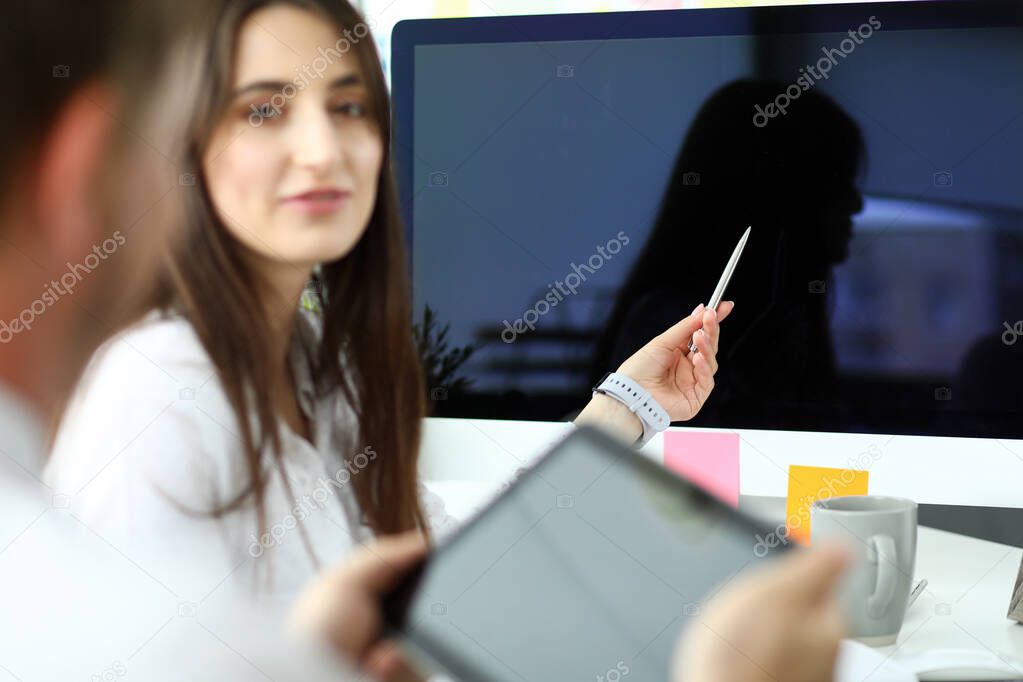 Female caucasian employee presenting some new data to colleagues