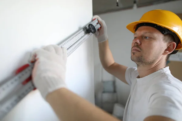 Worker making wall straight — Stock Image Worker making wall straight Stock Photo