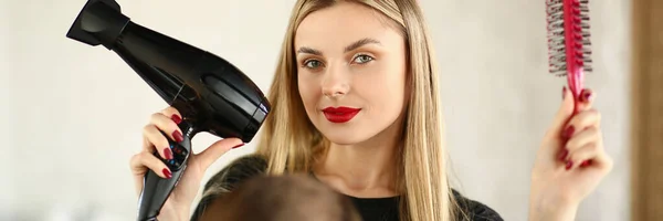 Blonde Hairstylist Showing Blow Dryer and Comb — Stock Photo, Image