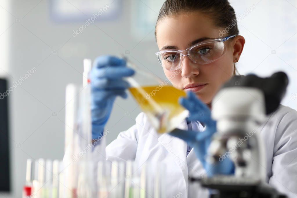 Concentrated female in white coat