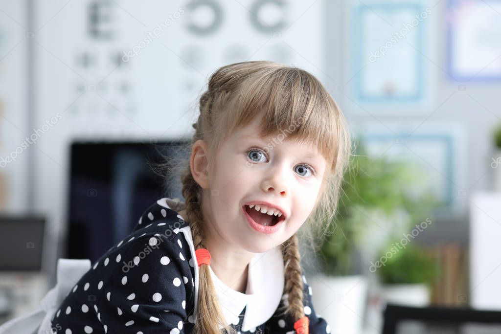 Joyous girl at doctor office