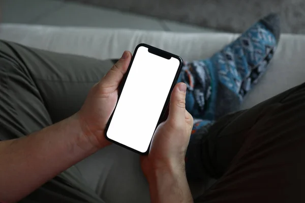 Мужчина держит в руках современный смартфон с чистым scereen — стоковое фото
