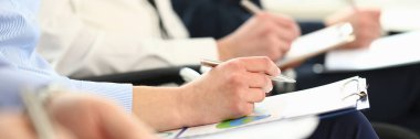 Bir grup insan seminer sırasında satır kollarını çırp