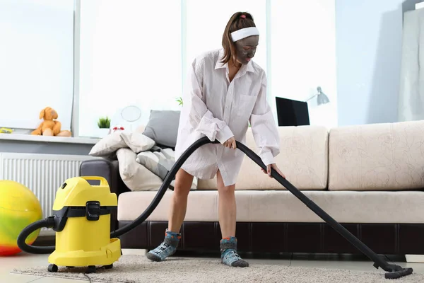 Young woman in beauty spa mask using vacuun cleaner — 스톡 사진