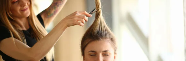 Tattooed Stylist Cutting Hair of Closed Eyes Woman — Stock Photo, Image