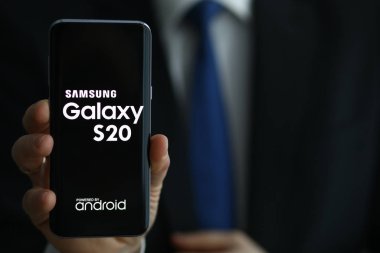 Businessman hold Samsung galaxy s20 smartphone in hand