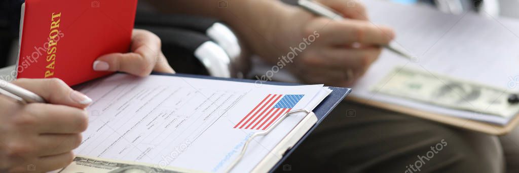 Male hand with green card USA form against airport