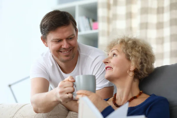 Elderly woman happily takes care from an adult son — Stock Photo, Image