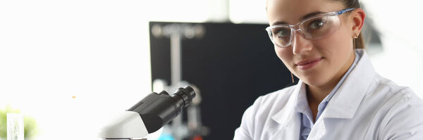 Smiling biomedical researcher in eyewear