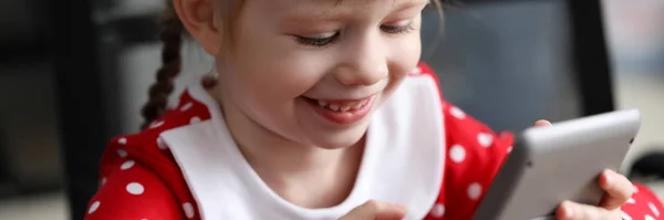 Sonriente niña en vestido rojo mantenga calculadora gris — Foto de Stock