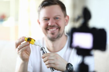 Man uses hemp oil for an electronic cigarette