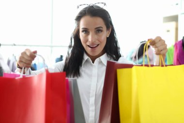 Stylish girl shows off packages with purchases