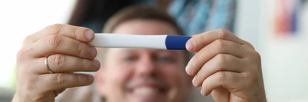 Happy man holding pregnancy test — Stock Photo, Image