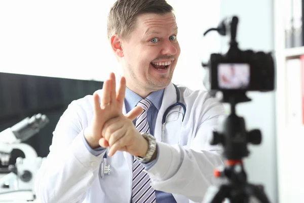 Доктор снимает видеоблог, объясняет язык жестов — стоковое фото