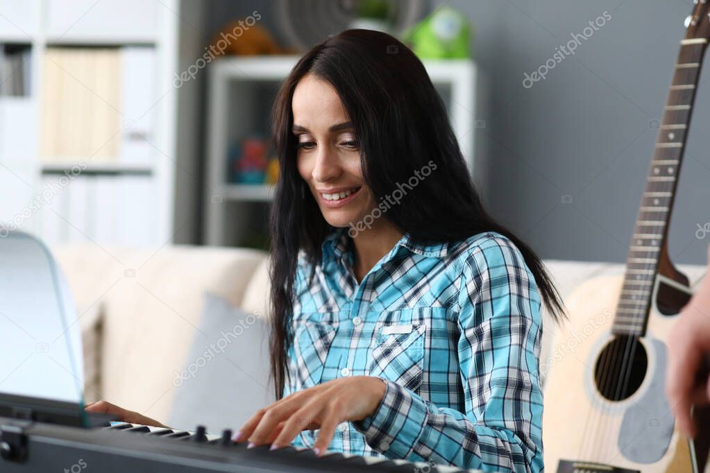 Woman playing keyboard, electronic instrument