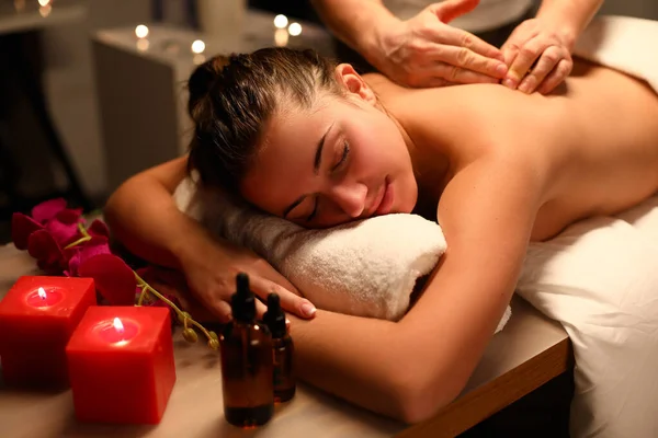 Girl relaxed lying massage, near candles and oil