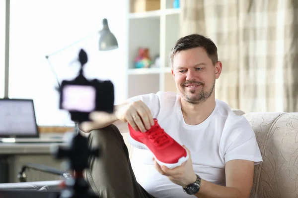 Guy front camera in apartment shows new sneakers