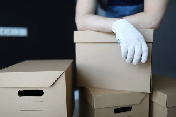 Gloved hands loader lie on cardboard boxes office — Stock Photo, Image