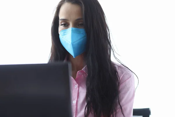 Businesswoman in blue mask use laptop portrait. Stock Image