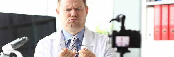Doctor in front camera is surprised by stethoscope — 스톡 사진